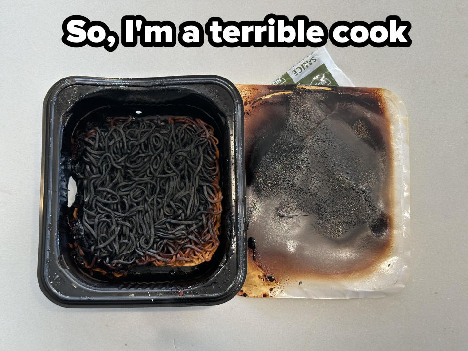 A pan of burnt noodles that look like wiggly black worms, with caption, "So, I'm a terrible cook"