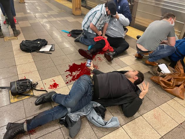 New Yorkers on their way to work help treat victims of the shooting on the Manhattan-bound platform of the 36th Street station. (Photo: Derek French/Shutterstock)