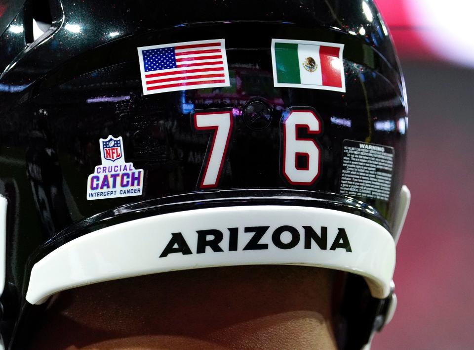 FILE -  Arizona Cardinals' Will Hernandez wears a United States flag and a Mexican flag on his helmet before the first half of an NFL football game against the Philadelphia Eagles, Sunday, Oct. 9, 2022, in Glendale, Ariz. The NFL returns to Mexico City on Monday, Nov. 21, 2022, when Arizona Cardinals play the San Francisco 49ers. The Cardinals have two Latino players on the roster -- Max Garcia and Will Hernandez.  (AP Photo/Darryl Webb, File)