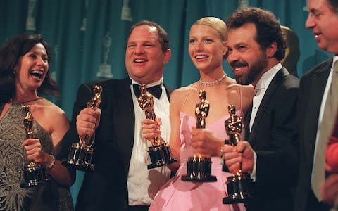 Gwyneth Paltrow with Harvey Weinstein on the night she won a Best Actress Oscar for Shakespeare in Love   - Credit: Monica Almeida/The New York Times