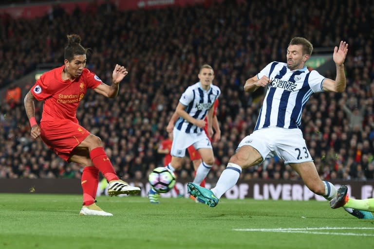 Liverpool's midfielder Roberto Firmino (L) takes a shot that is saved on October 22, 2016