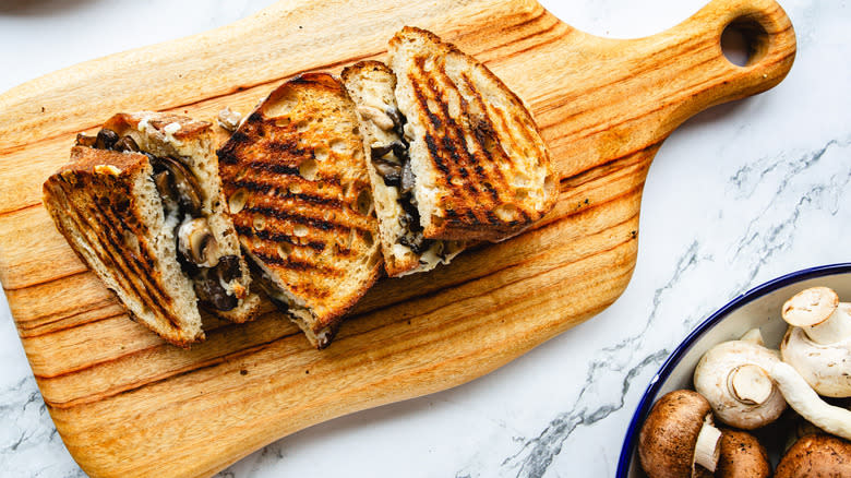 Three sandwich halves on cutting board