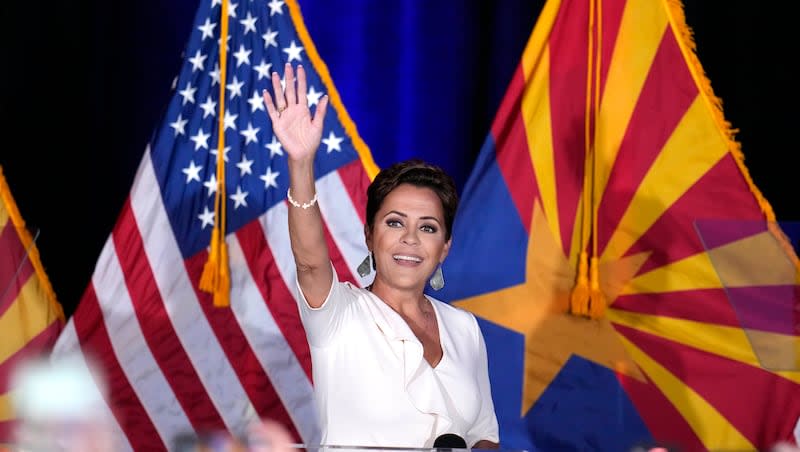 Republican Arizona Senate candidate Kari Lake waves to supporters as she arrives on stage after being declared the primary winner on Tuesday, July 30, 2024, in Phoenix.