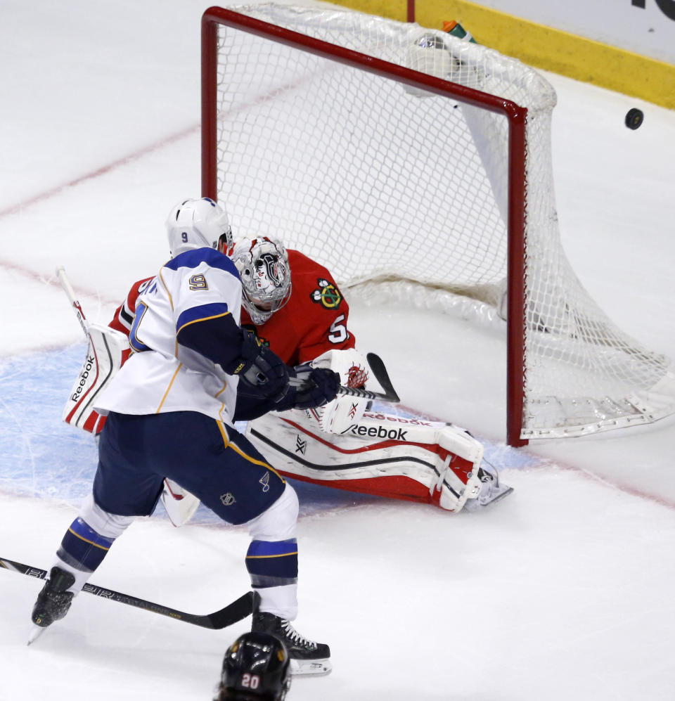 A shot on goal by St. Louis Blues left wing Jaden Schwartz (9) flies wide of the net past Chicago Blackhawks goalie Corey Crawford during the first period in Game 3 of a first-round NHL hockey Stanley Cup playoff series game Monday, April 21, 2014, in Chicago. (AP Photo/Charles Rex Arbogast)