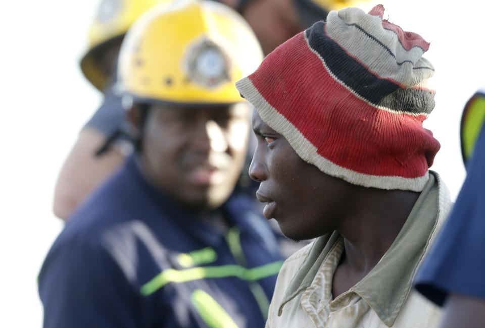 A suspected illegal miner is led away after being rescued from an abandoned gold shaft in Benoni