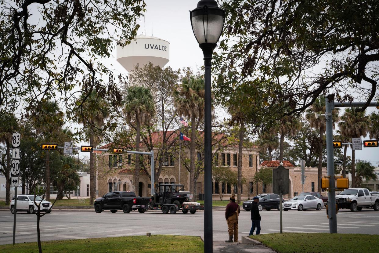 Two men walk away after visiting the Uvalde Plaza Fountain, where memorials honor the lives of 19 children and 2 teachers killed in the Robb Elementary School shooting on May 24, 2022, on N. Getty Street and W. Roberts Lane in Uvalde, Texas on Sunday, Nov. 20, 2022.