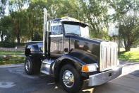 There are two ways to get that big rig feeling while driving a pickup: Convert your pickup into a faux Peterbilt, or take a real Peterbilt and cut it down to size with a pickup bed. This example took the latter course, preserving the Caterpillar diesel and 9-speed Eaton transmission of the original. Best of all, you don't need a commercial driver's license -- although you might get some snickers down at the TravelAmerica.