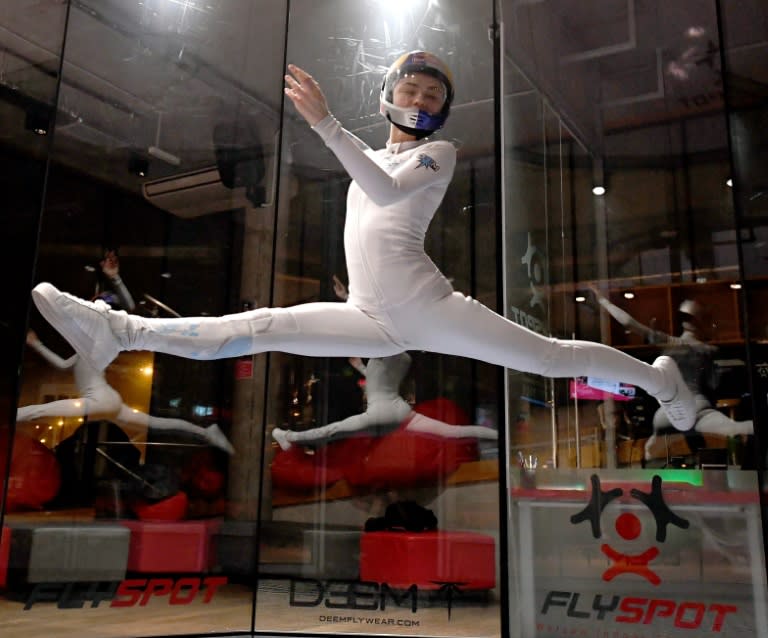 Maja Kuczynska, 17, makes airborne gymnastic moves during her skydiving performance inside a wind tunnel in Warsaw on February 19, 2017