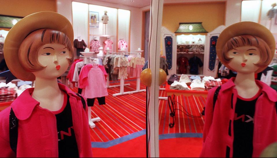 A mannequin is reflected in a mirror in the children's clothing department of the new Saks Fifth Avenue in the Town Center mall.