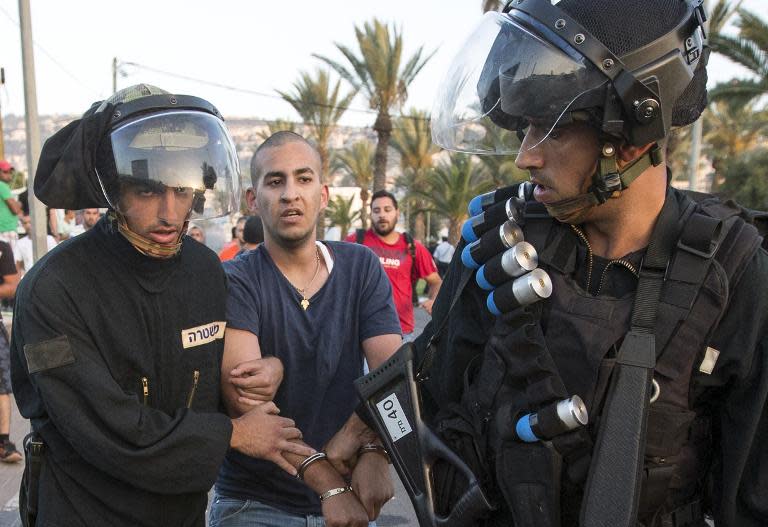 Israeli riot police detain a Palestinian protester during clashes in the Arab Israeli city of Arara, July 5, 2014