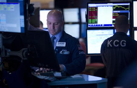 Traders work on the floor of the New York Stock Exchange in New York, April 14, 2014. REUTERS/Carlo Allegri