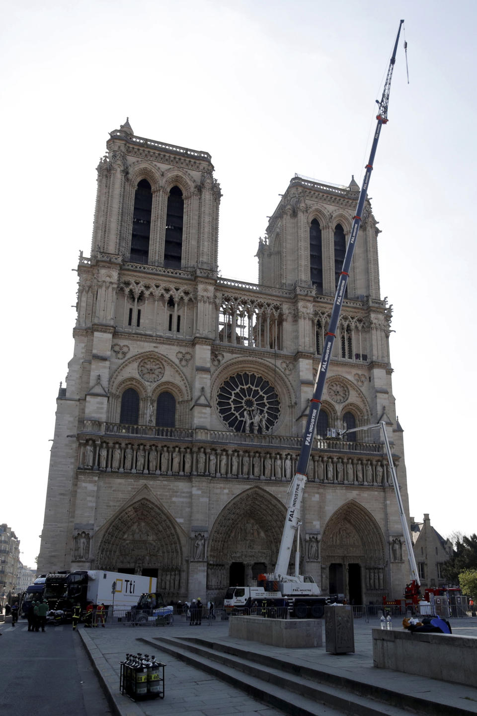 A crane works at Notre-Dame cathedral in Paris, Friday, April 19, 2019. Rebuilding Notre Dame, the 800-year-old Paris cathedral devastated by fire this week, will cost billions of dollars as architects, historians and artisans work to preserve the medieval landmark. (Philippe Wojazer/Pool via AP)