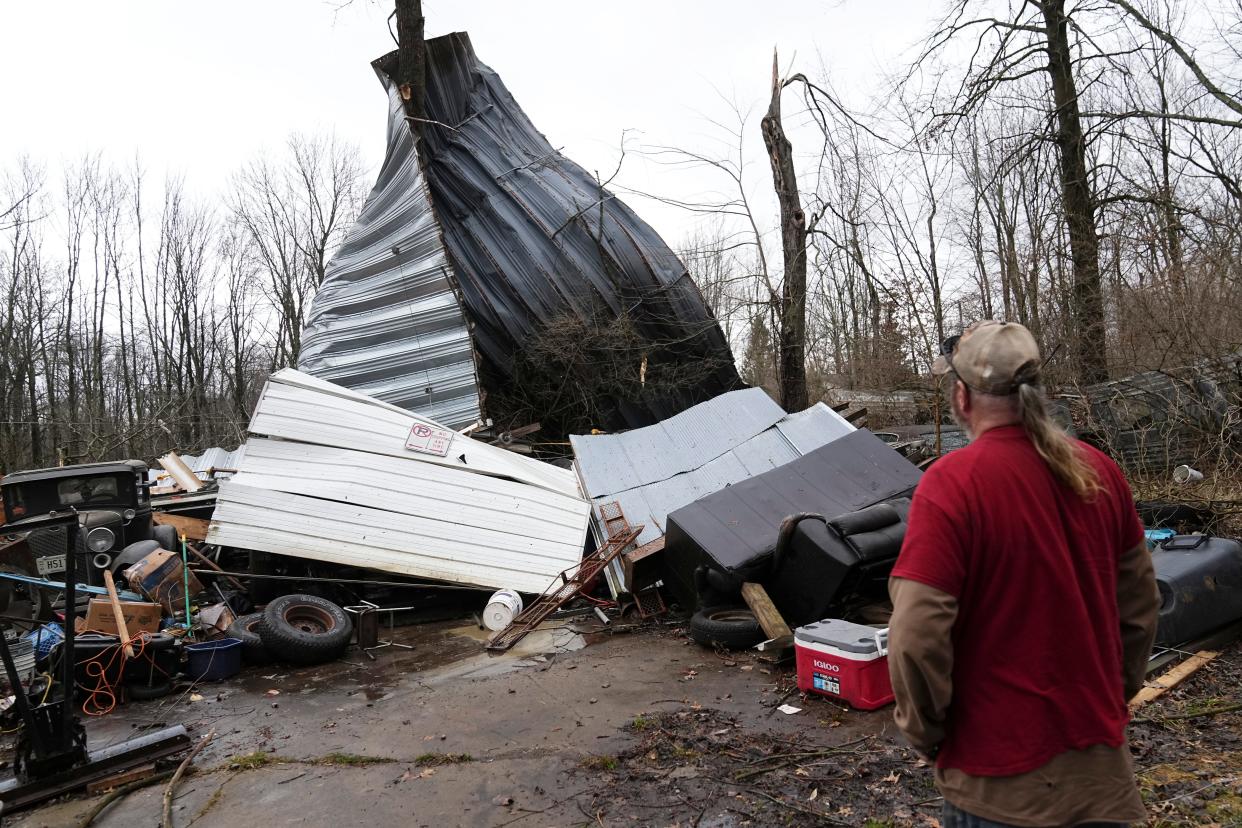 Feb 28, 2024; Pataskala, Ohio, USA; Dave Coleman assesses the damage to his garage after a potential tornado touched down in the early morning. Winds ripped off the roof to his workshop that was large enough to store a semil.