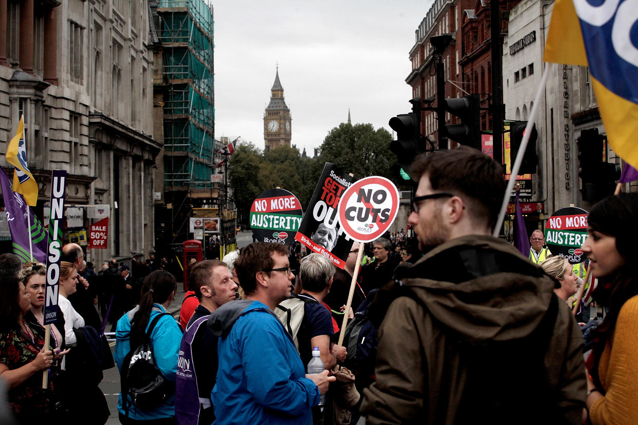 LONDON, ENGLAND - OCTOBER 18:  Demonstrators walk past Whitehall and Big Ben during a march organised by the Trades Union Congress on October 18, 2014 in London, England. Thousands attended the march organised by the TUC and called 'Britain Needs A Pay Rise' after a week of union strikes demanding an end to the government's squeeze on public sector pay, which has been in place since 2008.  (Photo by Mary Turner/Getty Images)