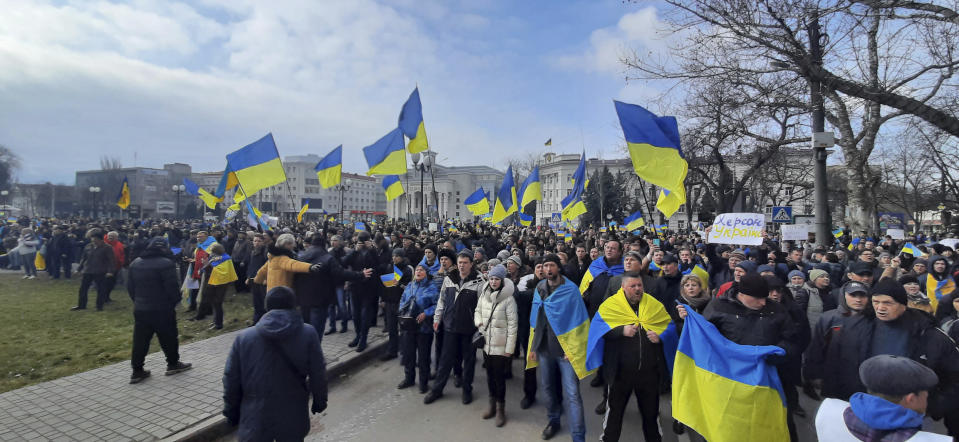 People wave Ukrainian flags during a rally against the Russian occupation in Svobody (Freedom) Square in Kherson, Ukraine, Saturday, March 5, 2022. Ever since Russian forces took the southern Ukrainian city of Kherson in early March, residents sensed the occupiers had a special plan for their town. Now, amid a crescendo of warnings from Ukraine that Russia plans to stage a sham referendum to transform the territory into a pro-Moscow "people's republic," it appears locals guessed right. (AP Photo/Olexandr Chornyi)