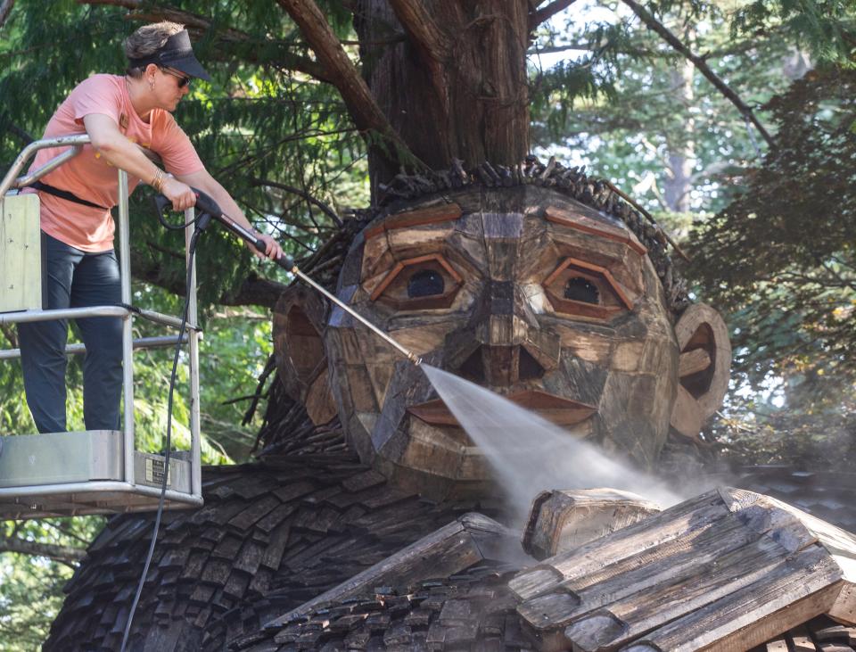 Jenny Zeller, Arts and Nature Curator at Bernheim Forest, cleaned the face of giant troll Mama Loumari at as part of an annual cleaning and repair of the wooden sculptures. July 20, 2022
