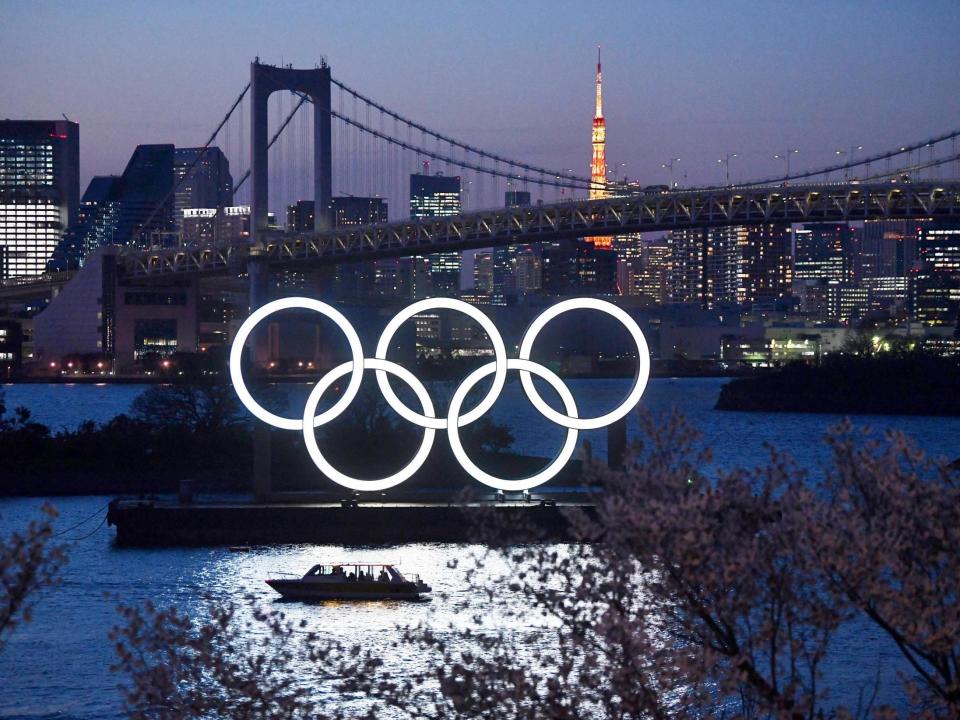 A boat sails past the Olympic rings in Tokyo: Getty Images