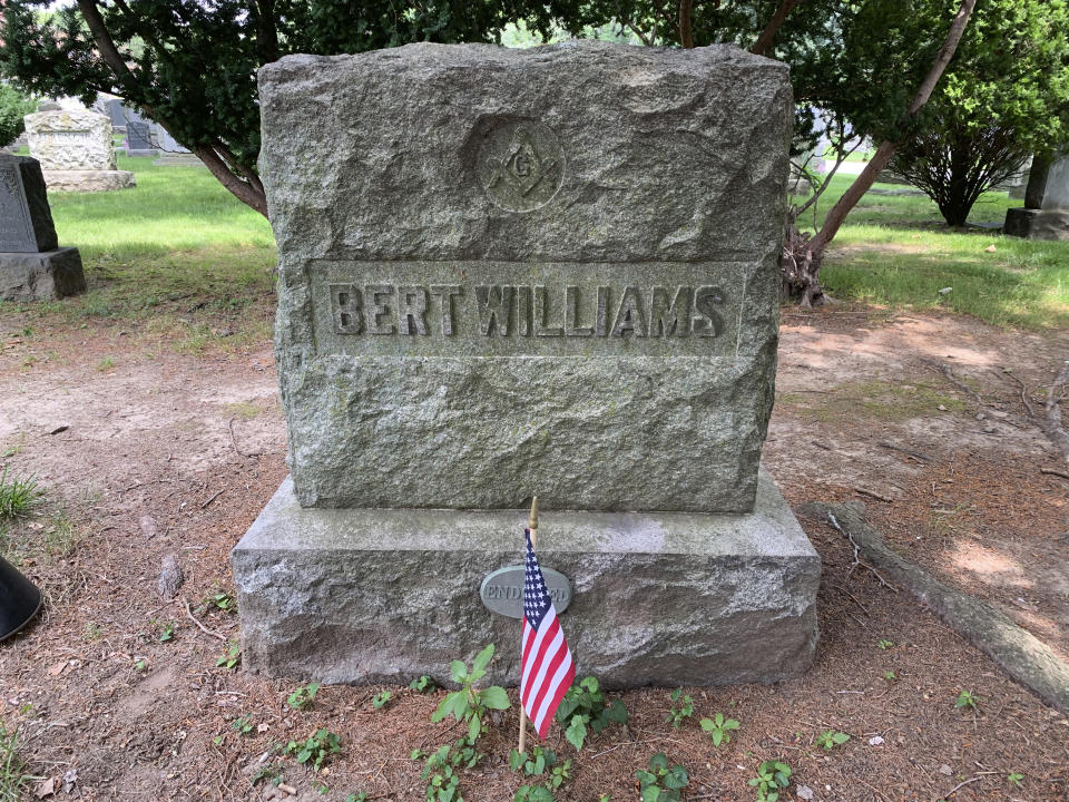 The gravesite of pioneering Black comedian and singer Bert Williams appears on June 27, 2021, as part of a tour of jazz and vaudeville greats at Woodlawn Cemetery in the Bronx borough of New York. Williams was a star on Broadway and in film, and his recording of his most famous song, “Nobody,” is played on an old Victrola during the tour. (AP Photo/Julia Rubin)