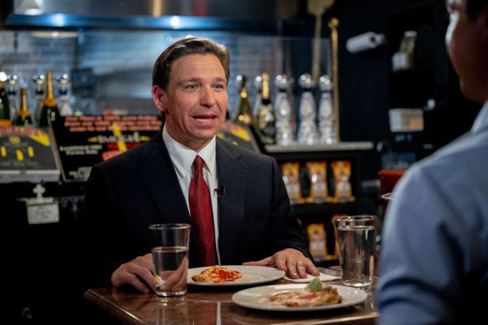 Gov. Ron DeSantis eats pizza.