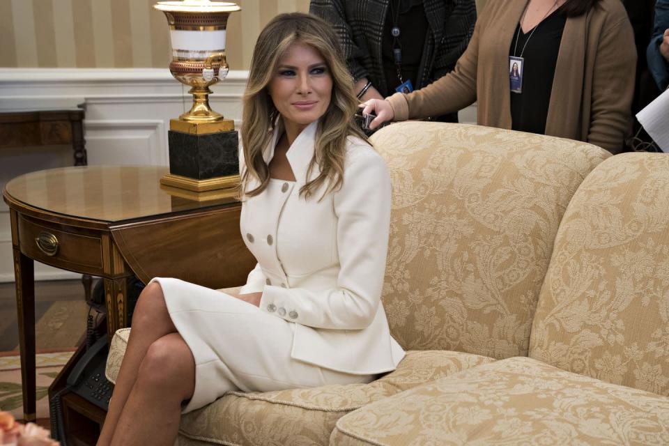 <p>In her first official appearance at the White House since Trump's inauguration, Melania is seen here in a custom-made white skirt suit by Karl Lagerfeld.</p>
