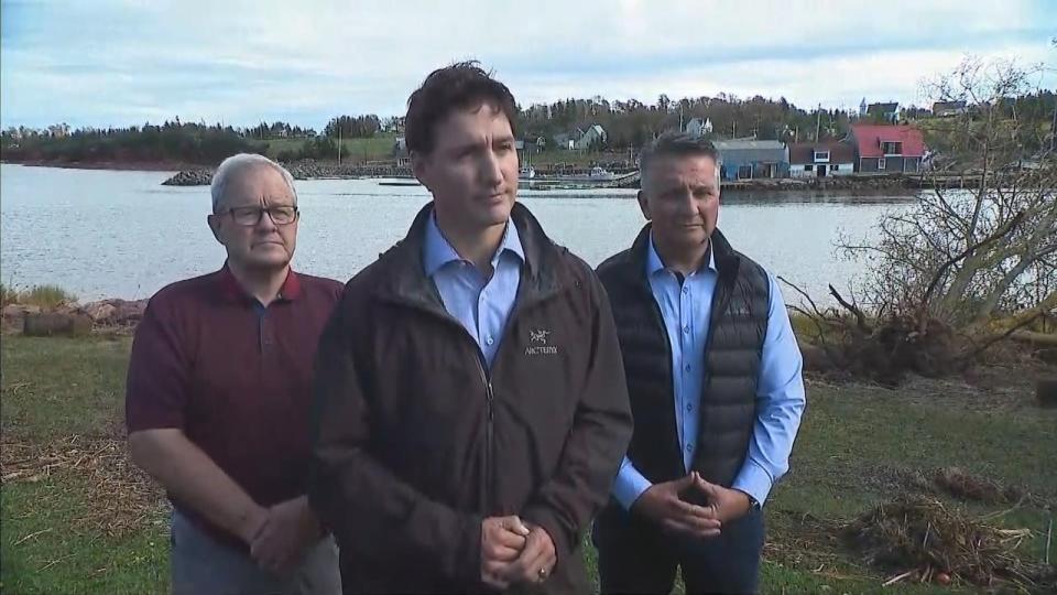 While on P.E.I., Prime Minister Justin Trudeau met with locals affected by the storm, as well as MPs Lawrence MacAulay, left, and Heath MacDonald, right.