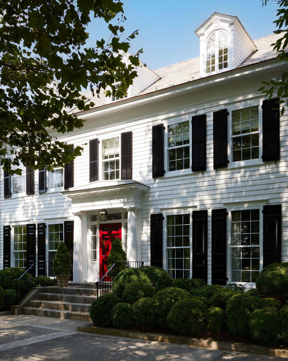 a white house with a red door