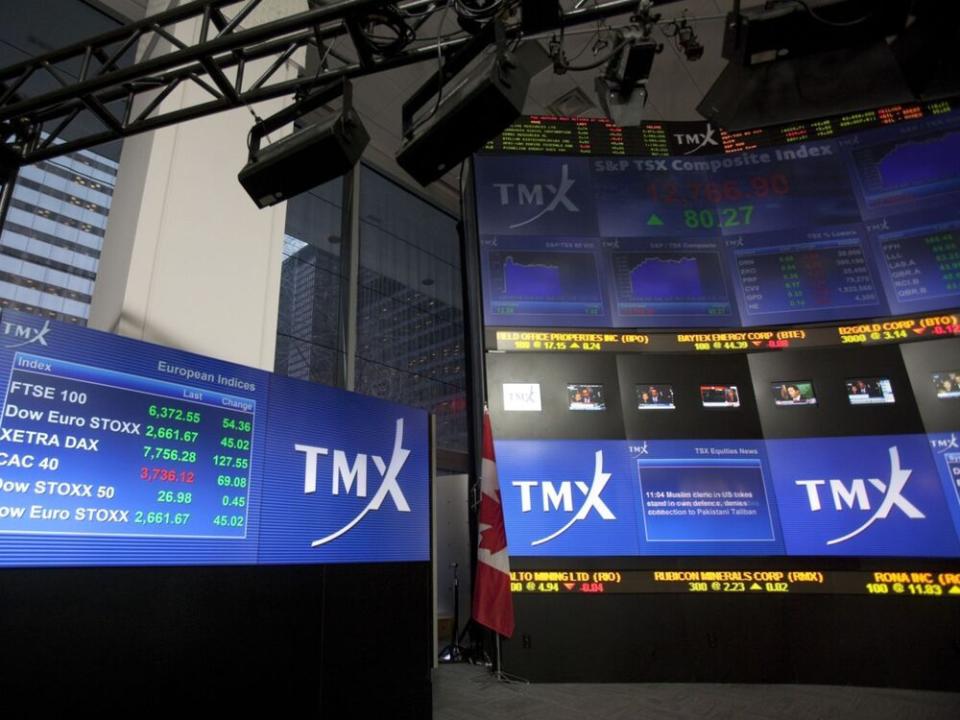  TMX Group Inc. signage and stock prices are displayed on a screen in the broadcast centre of the Toronto Stock Exchange.