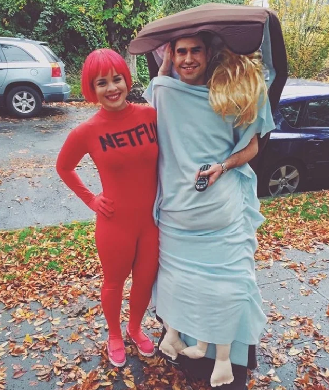 One person dressed in a red suit labeled "Netflix" and another dressed as a bed