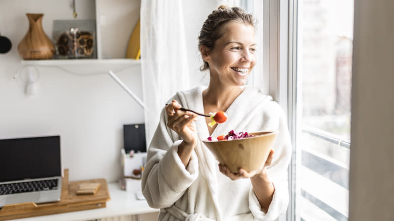 woman eating salad with tomatoes