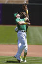 Oakland Athletics third baseman Matt Chapman, foreground, catches a pop out hit by Kansas City Royals' Carlos Santana in front of second baseman Tony Kemp during the first inning of a baseball game in Oakland, Calif., Sunday, June 13, 2021. (AP Photo/Jeff Chiu)