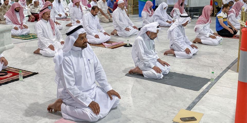 Muslim worshippers perform the "Tarawih" nightly prayer during the holy month of Ramadan, while keeping their distance amid the COVID-19 pandemic, at the Grand Mosque, Islam's holiest site, in the Saudi city of Mecca, late on May 8, 2020. -