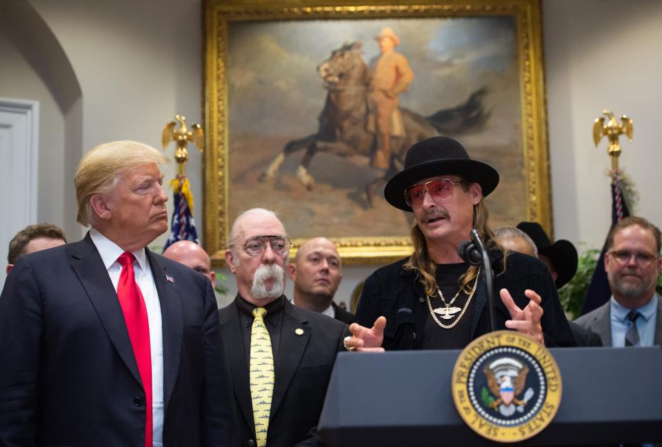 US President Donald Trump watches on as musician Kid Rock (R) speaks after signing the Hatch-Goodlatte Music Modernization A in the Roosevelt Room of the White House in Washington, DC, October 11, 2018.