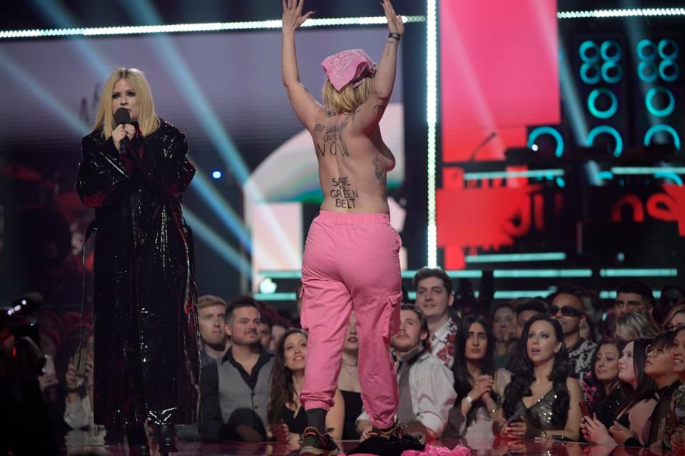 An environmental protestor interrupts Avril Lavigne speaking onstage at the 2023 Juno Awards (Getty Images)