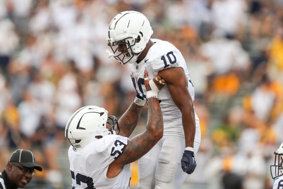 Aug 31, 2024; Morgantown, West Virginia, USA; Penn State Nittany Lions running back Nicholas Singleton (10) runs the ball for a touchdown and celebrates with Penn State Nittany Lions offensive lineman Nick Dawkins (53) during the third quarter against the West Virginia Mountaineers at Mountaineer Field at Milan Puskar Stadium. Mandatory Credit: Ben Queen-USA TODAY Sports