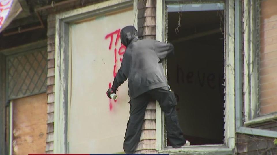 <div>A protester sprays the side of a vacant UC Berkeley-owned building near campus. May 15, 2024.</div>