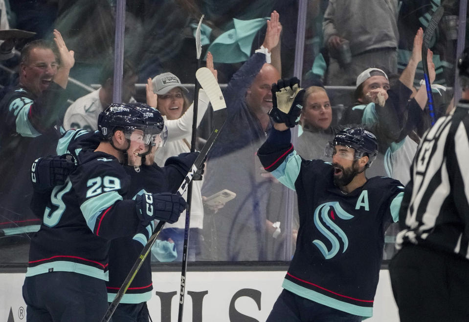 Seattle Kraken defenseman Vince Dunn (29) and right wing Jordan Eberle, right, celebrate a goal by left wing Tye Kartye, center, against the Dallas Stars during the second period of Game 6 of an NHL hockey Stanley Cup second-round playoff series Saturday, May 13, 2023, in Seattle. (AP Photo/Lindsey Wasson)