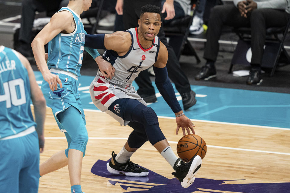 Washington Wizards guard Russell Westbrook (4) drives to the basket while guarded by Charlotte Hornets guard LaMelo Ball (2) during the first half of an NBA basketball game in Charlotte, N.C., Sunday, Feb. 7, 2021. (AP Photo/Jacob Kupferman)