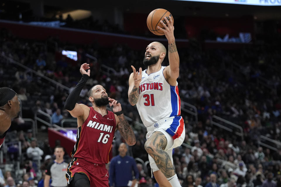 Detroit Pistons guard Evan Fournier (31) drives on Miami Heat forward Caleb Martin (16) in the first half of an NBA basketball game in Detroit, Sunday, March 17, 2024. (AP Photo/Paul Sancya)