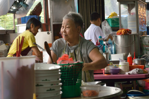 Faces like these are part of the living heritage of a shop like Lai Foong, but are fading fast. This 'aunty' runs the char kuey teow stall.