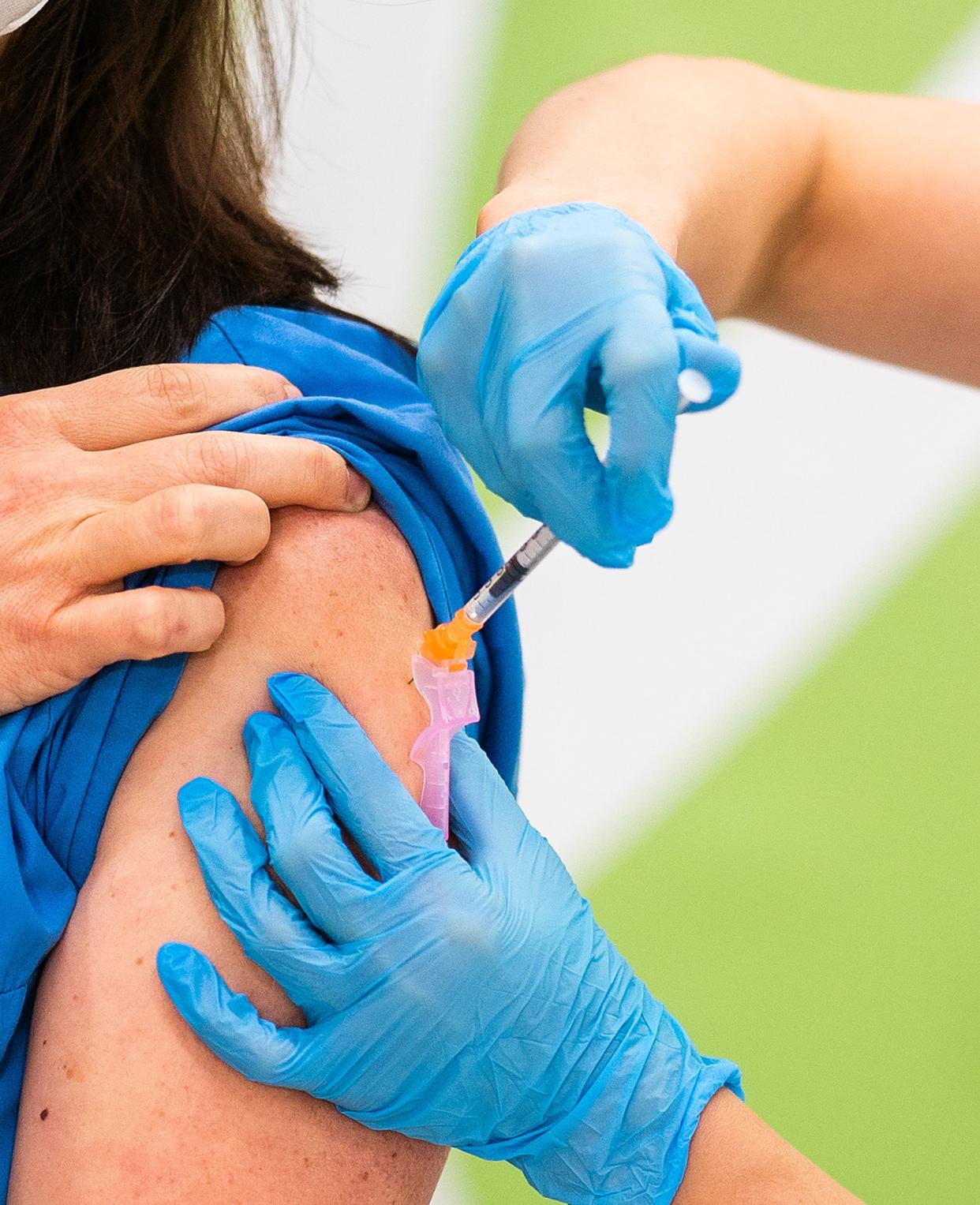 Medical personnel is given the Pfizer-Biontech Covid-19 corona virus vaccine at the Favoriten Clinic in Vienna, Austria (APA/AFP via Getty Images)