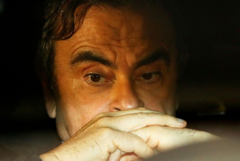 FILE PHOTO: Former Nissan Motor Chairman Carlos Ghosn sits inside a car as he leaves his lawyer's office after being released on bail from Tokyo Detention House, in Tokyo