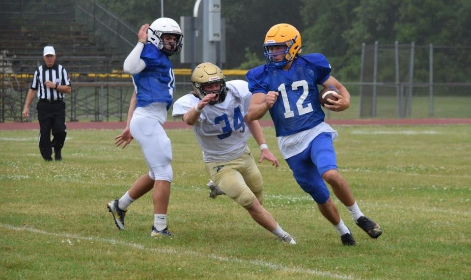 Jefferson’s Myles Tackett (12) gets around the edge for the Blue as St. Mary Catholic Central’s Riley DeSarbo gives chase during last year's Monroe County Region All-Star Football Game. This year Monroe and Lenawee Counties will compete against each other in the All-Star Game.
