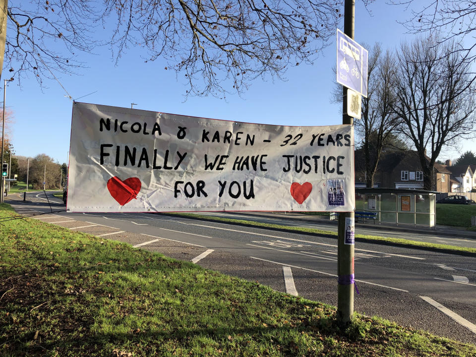 Supporters of the families of Nicola Fellows and Karen Hadaway, the Babes in the Wood, place a banner showing after Russell Bishop was convicted of their murders. (PA)