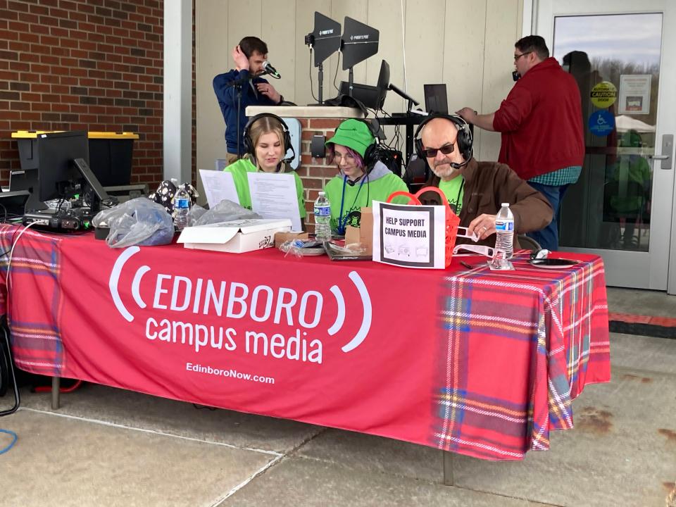 David Hurd, PennWest planetarium director and geosciences professor, seated at right, keeps visitors at the university's eclipse watch party informed about the eclipse on campus radio station WFSE-FM throughout the afternoon on Monday. With him are student radio personalities Bailey Mutschler, left, and Sophia Elder.