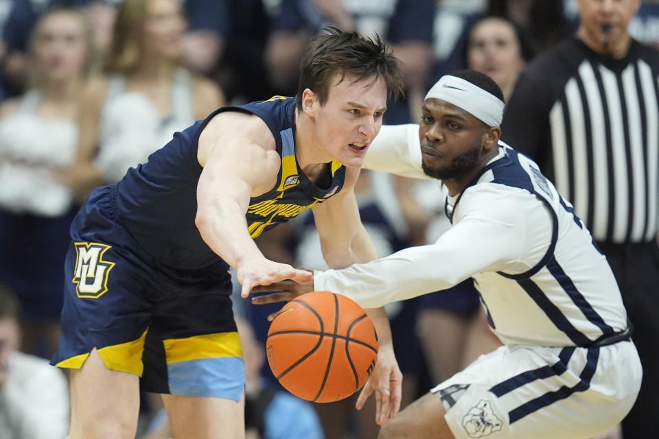 Marquette's Tyler Kolek (11) is defended by Butler's Posh Alexander (5) during the first half of an NCAA college basketball game Tuesday, Feb. 13, 2024, in Indianapolis. (AP Photo/Darron Cummings)