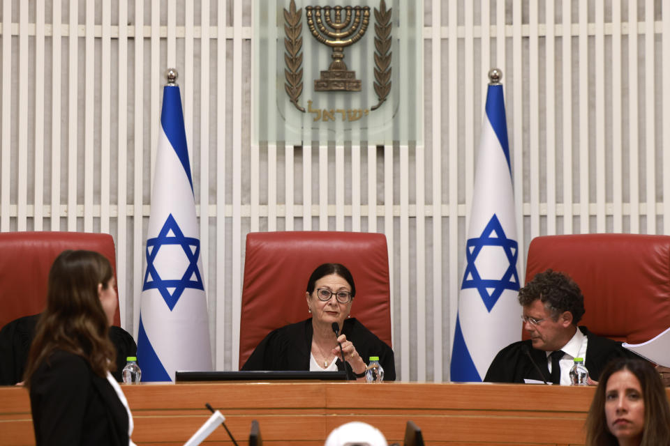 President of the Israeli Supreme Court Esther Hayut, center, and judges assemble to hear petitions against a law that would make it harder to remove a sitting prime minister at the court premises in Jerusalem, Thursday, Sept. 28, 2023. (Menahem Kahana/Pool Photo via AP)