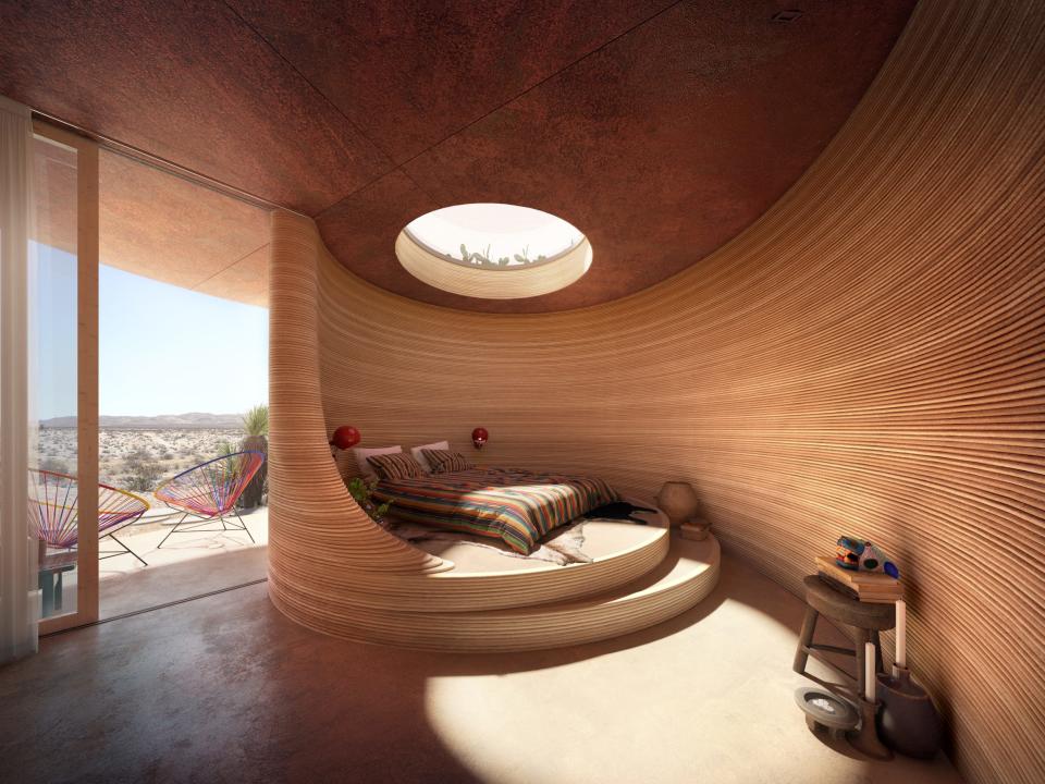 Renderings of the El Cosmico property shows the inside of a hotel room with curved walls and a bed.