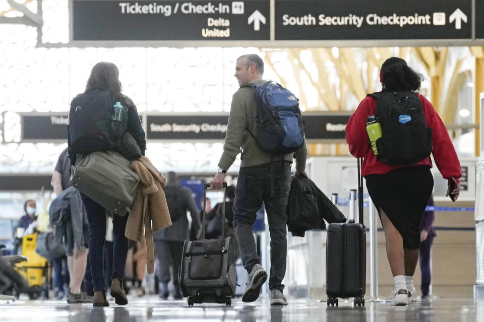 People walk through Reagan Washington National Airport in Arlington, Va., Wednesday, Nov. 22, 2023. Passengers are on the move ahead of the Thanksgiving Holiday. (AP Photo/Susan Walsh)