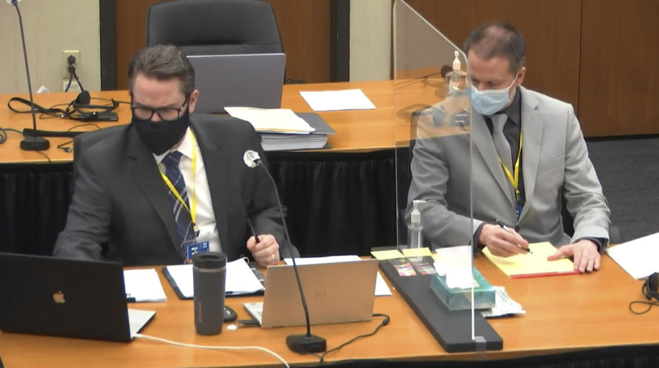 In this image from video, defense attorney Eric Nelson, left, and defendant, former Minneapolis police Officer Derek Chauvin, right, listen as Hennepin County Judge Peter Cahill presides Friday, April 9, 2021, in the trial of Chauvin at the Hennepin County Courthouse in Minneapolis, Minn. Chauvin is charged in the May 25, 2020 death of George Floyd. (Court TV via AP, Pool)