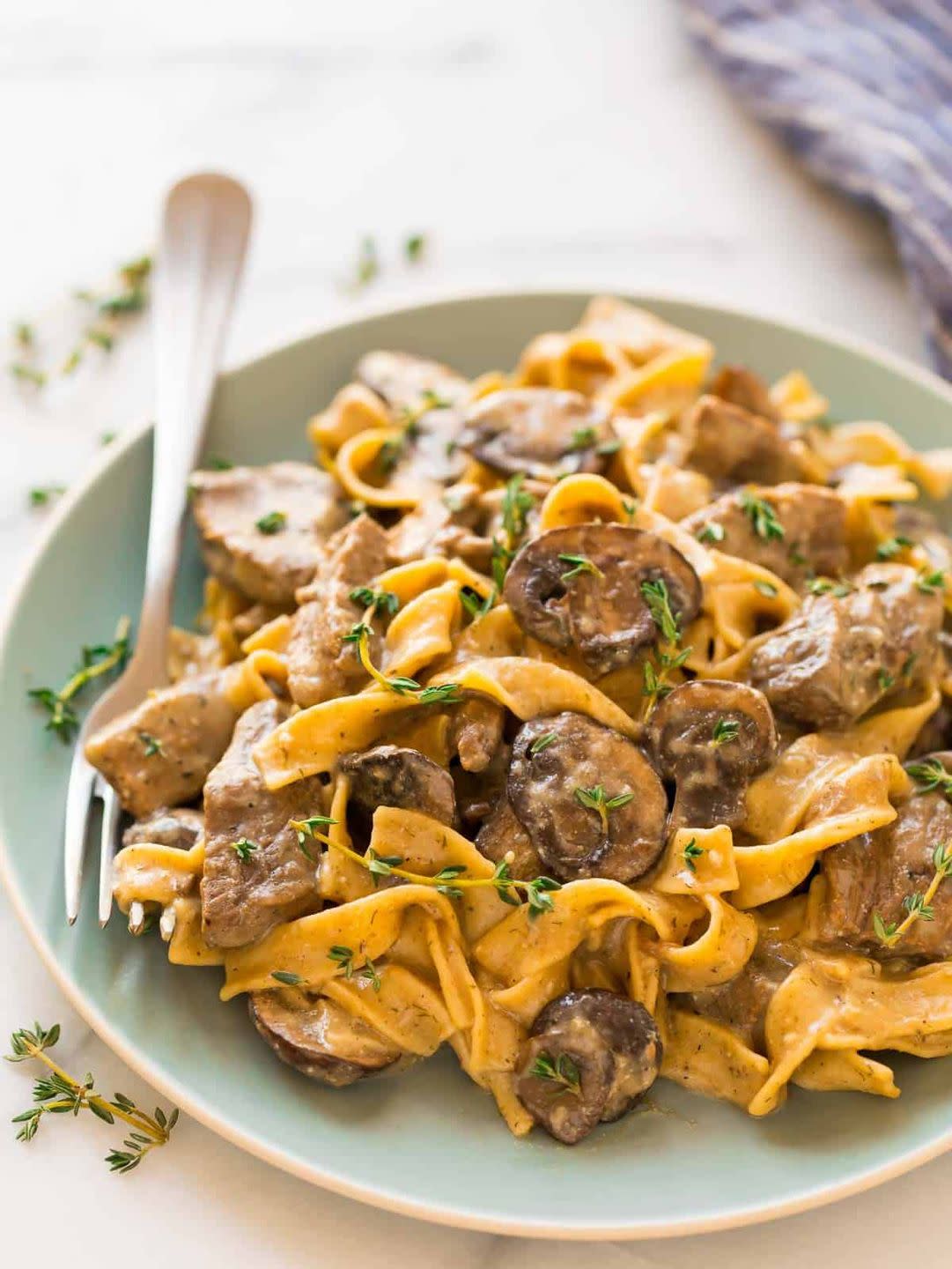 slow cooker beef stroganoff on light blue plate